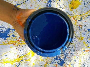 person holding black round container